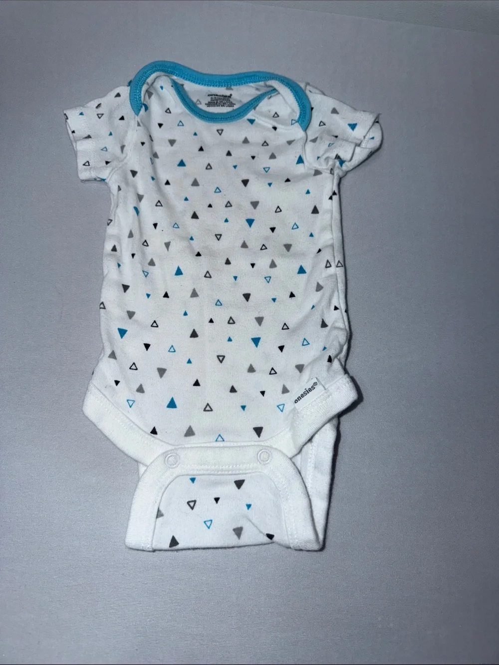 White Baby Onesie with Blue and Gray Triangle Print